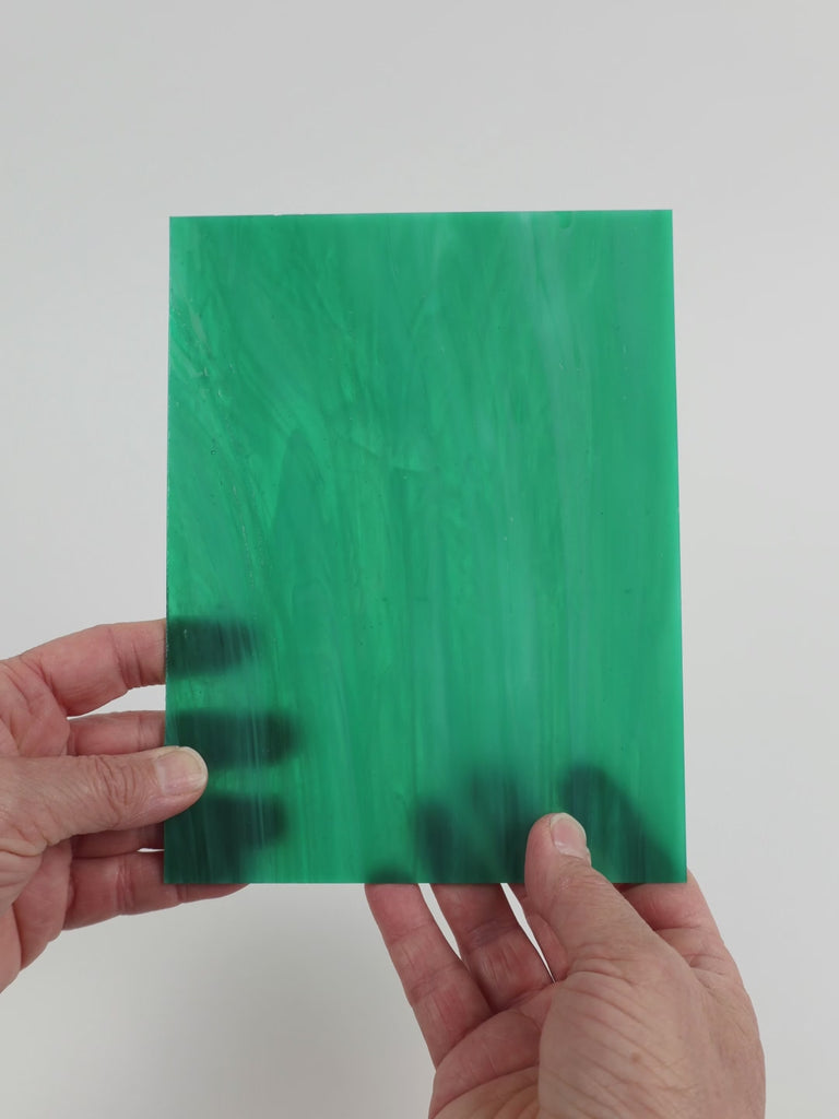 Video of the Sea green glass plate in translucent teal, 15x19cm, held up and tilted to show its pattern and transparency