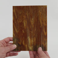 Video of the Burnt Sugar glass plate in translucent brown, 15x19cm, held up and tilted to show its pattern and transparency