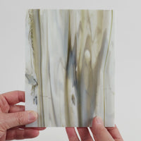 Video of the marbled grey glass plate in grey marbled translucent, 15x19cm, held up and tilted to show its pattern and transparency
