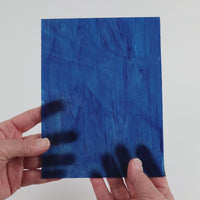 Video of the Ocean Tides glass plate in translucent turquoise, 15x19cm, held up and tilted to show its pattern and transparency
