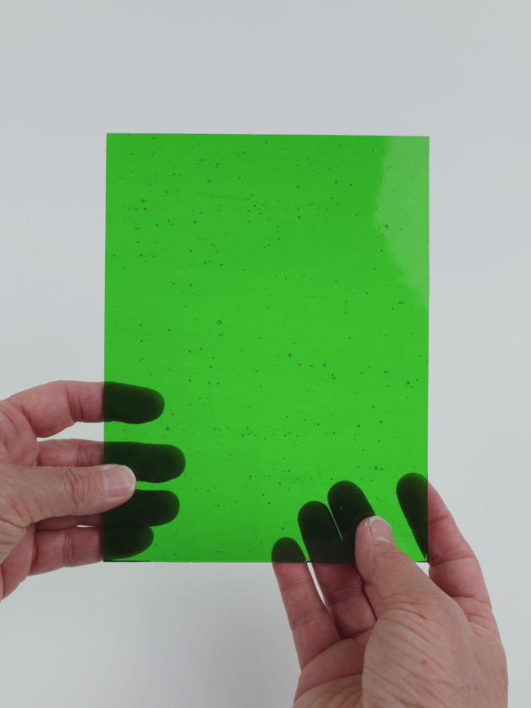 Video of the Deep Kiwi glass plate in transparent green, 15x19cm, held up and tilted to show its pattern and transparency