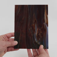 Video of the Oak glass plate in opaque brown, 15x19cm, held up and tilted to show its pattern and transparency