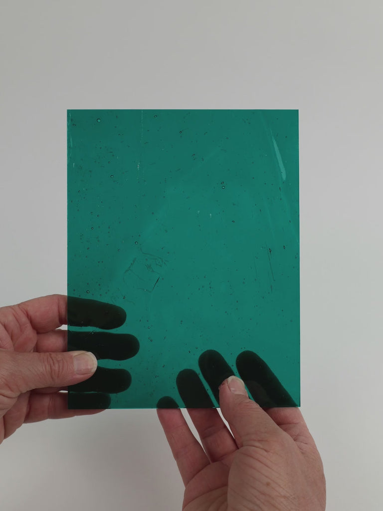 Video of the Deep Teal glass plate in transparent teal, 15x19cm, held up and tilted to show its pattern and transparency