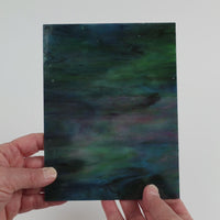 Video of the Indigo rainbow glass plate in translucent blue, 15x19cm, held up and tilted to show its pattern and transparency
