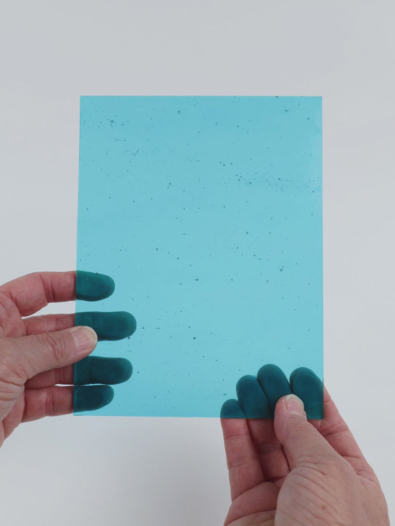 Video of the pale Light Turquoise glass plate in translucent turquoise, 15x19cm, held up and tilted to show its pattern and transparency