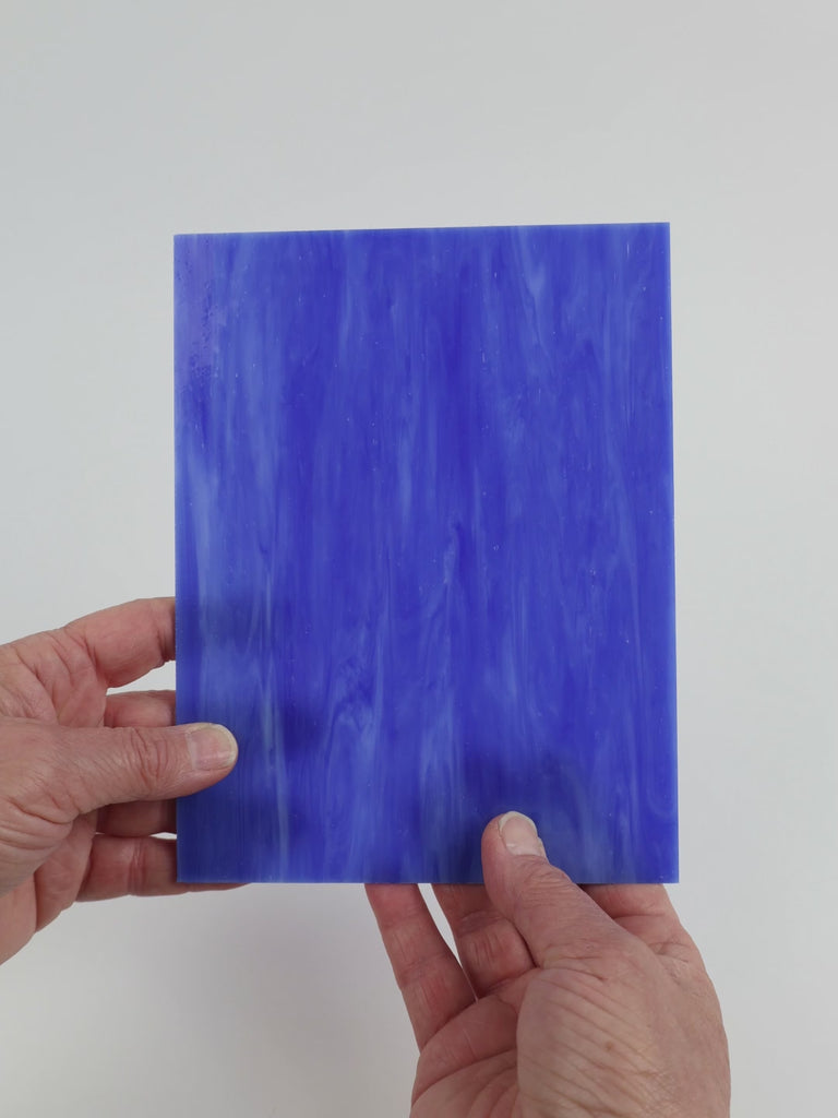 Video of the Mid Blue glass plate in translucent blue, 15x19cm, held up and tilted to show its pattern and transparency