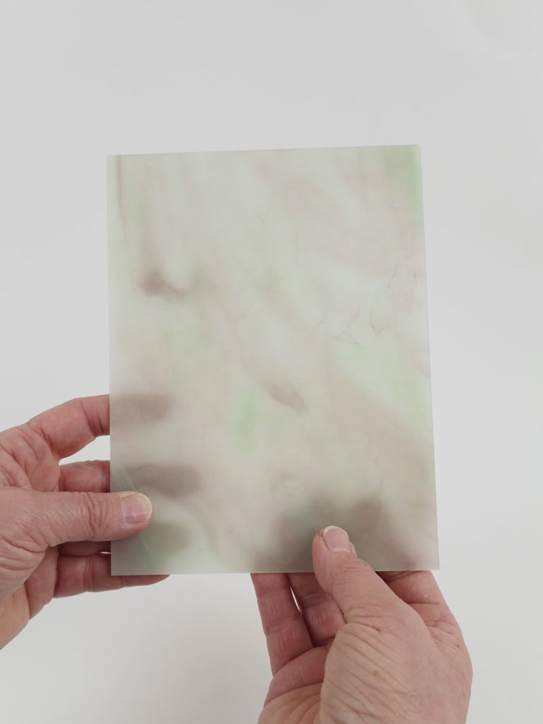 Video of the Light green Lilac Stipple glass plate in translucent green, 15x19cm, held up and tilted to show its pattern and transparency