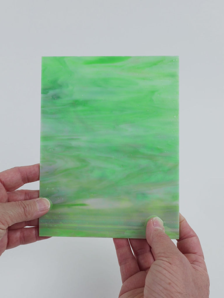 Video of the Mantis Pearlescent glass plate in iridised translucent green, 15x19cm, held up and tilted to show its pattern and transparency
