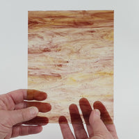 Video of the brown wispy glass plate in brown transparant, 15x19cm, held up and tilted to show its pattern and transparency