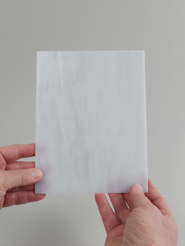 Video of the stone glass plate in grey translucent, 15x19cm, held up and tilted to show its pattern and transparency