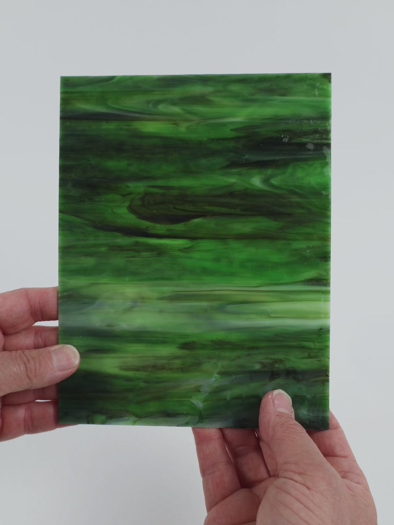 Video of the Evergreen Ripple glass plate in ripple translucent green, 15x19cm, held up and tilted to show its pattern and transparency