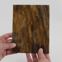 Video of the Deep Brown Marble glass plate in translucent brown, 15x19cm, held up and tilted to show its pattern and transparency