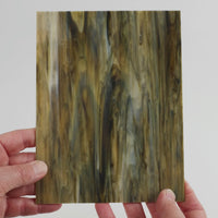 Video of the hardwood glass plate in brown translucent, 15x19cm, held up and tilted to show its pattern and transparency